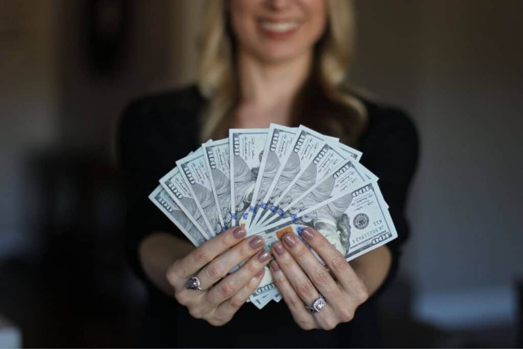 Woman fanning 100 dollar bills